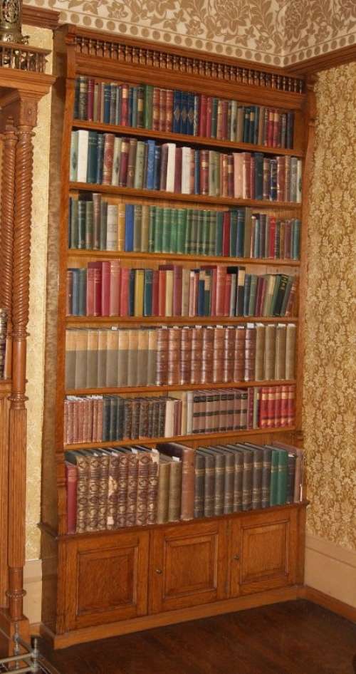 A bookcase with seven shelves and cabinets at the bottom.